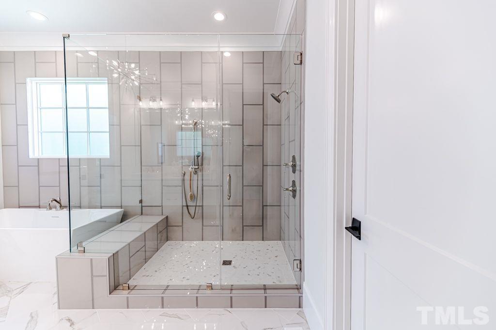 10822 Grand Journey Avenue Raleigh, NC 27614 - Photo 21 of 41 a bathroom with a bathtub and a shower