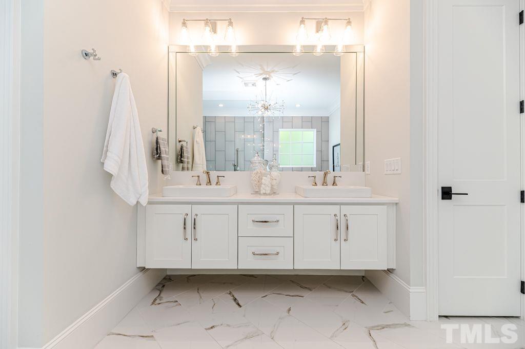 10822 Grand Journey Avenue Raleigh, NC 27614 - Photo 22 of 41 a bathroom with a double vanity sink and a mirror