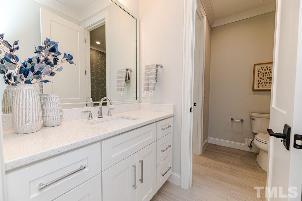 10822 Grand Journey Avenue Raleigh, NC 27614 - Photo 26 of 41 a bathroom with a sink and a mirror