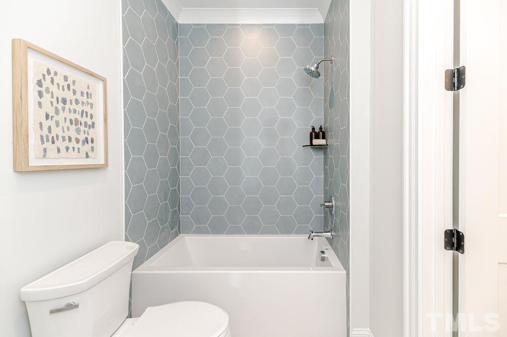 10822 Grand Journey Avenue Raleigh, NC 27614 - Photo 27 of 41 a bathroom with a toilet and a bathtub
