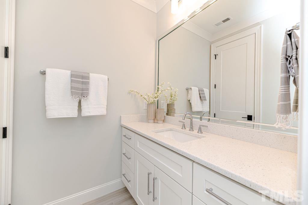 10822 Grand Journey Avenue Raleigh, NC 27614 - Photo 29 of 41 a bathroom with a sink and a mirror