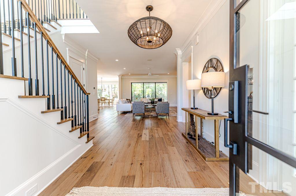 10822 Grand Journey Avenue Raleigh, NC 27614 - Photo 3 of 41 a view of a hallway with wooden floor and stairs