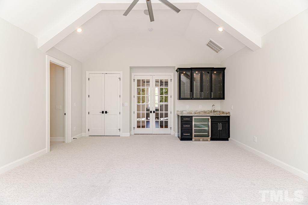 10822 Grand Journey Avenue Raleigh, NC 27614 - Photo 33 of 41 an empty room with furniture and a flat screen tv