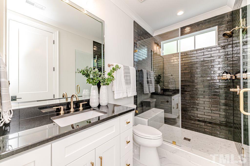 10822 Grand Journey Avenue Raleigh, NC 27614 - Photo 34 of 41 a bathroom with a sink a toilet a mirror and shower