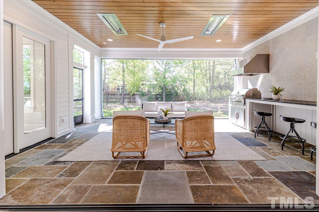 10822 Grand Journey Avenue Raleigh, NC 27614 - Photo 36 of 41 a living room with patio furniture and floor to ceiling windows