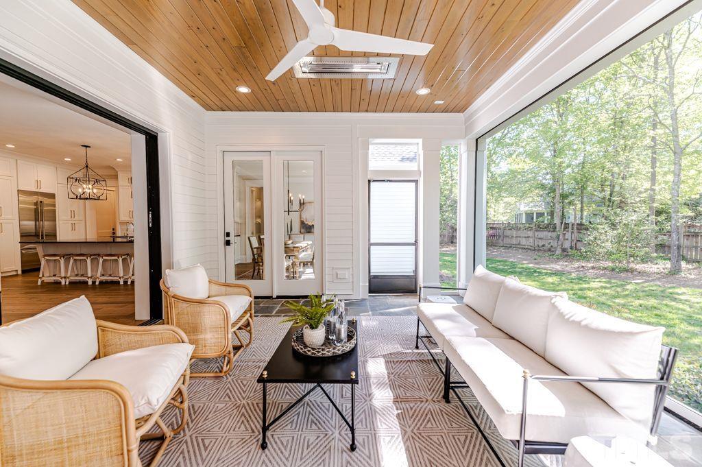 10822 Grand Journey Avenue Raleigh, NC 27614 - Photo 38 of 41 a living room with furniture and a floor to ceiling windows