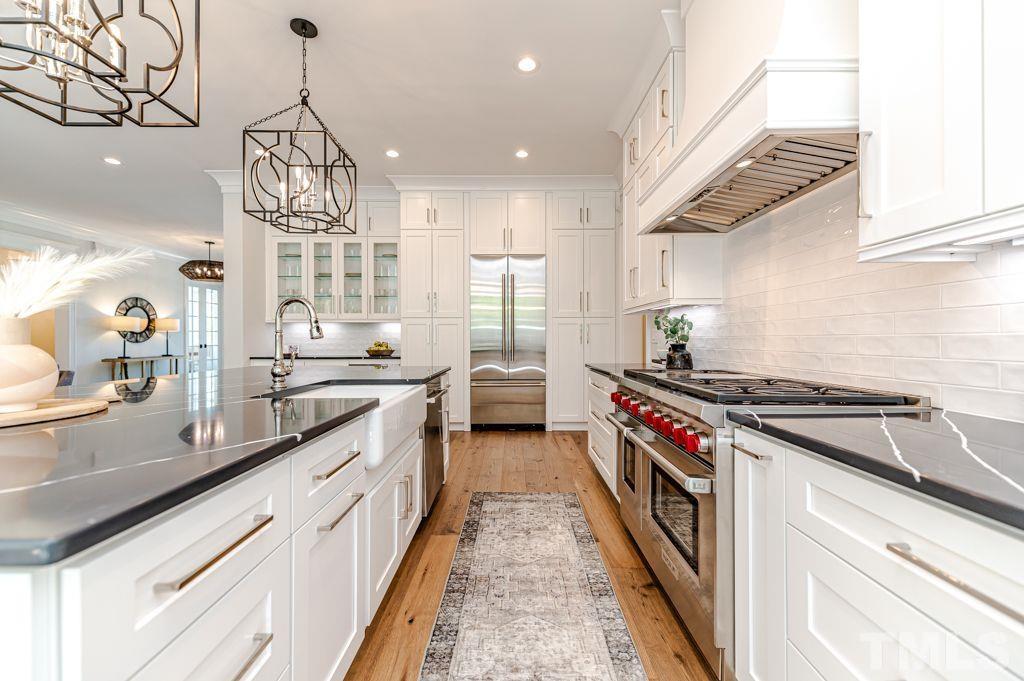 10822 Grand Journey Avenue Raleigh, NC 27614 - Photo 10 of 41 a kitchen with stainless steel appliances granite countertop a lot of counter space