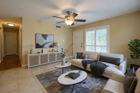 a living room with furniture a rug and a chandelier