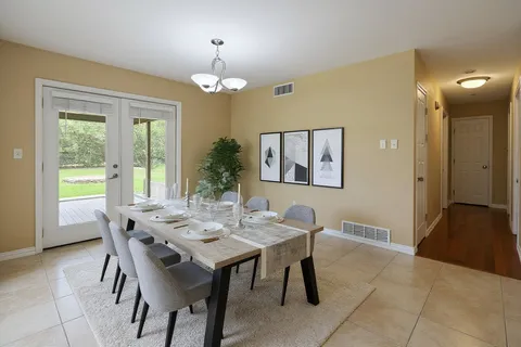 a view of a dining room with furniture and chandelier