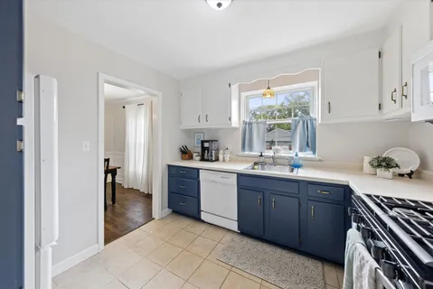 a kitchen with a sink window and cabinets