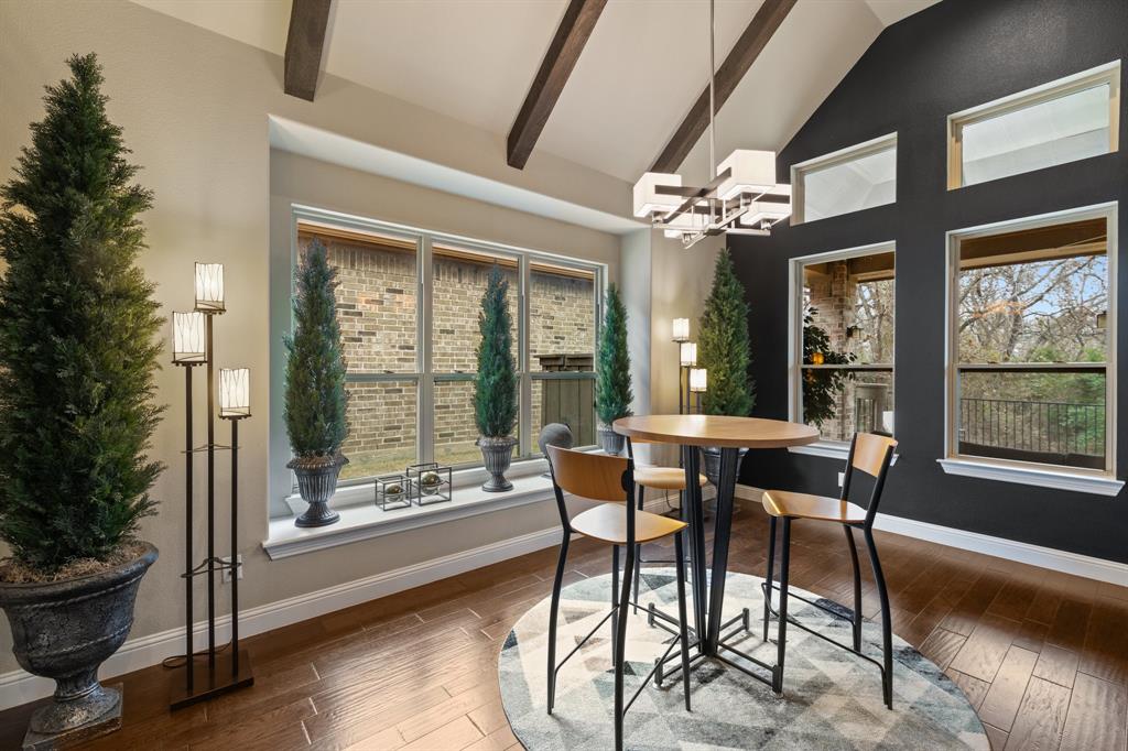 4711 Taylor Lane Grapevine, TX 76051 - Photo 13 of 31 a dining room with furniture a chandelier and wooden floor
