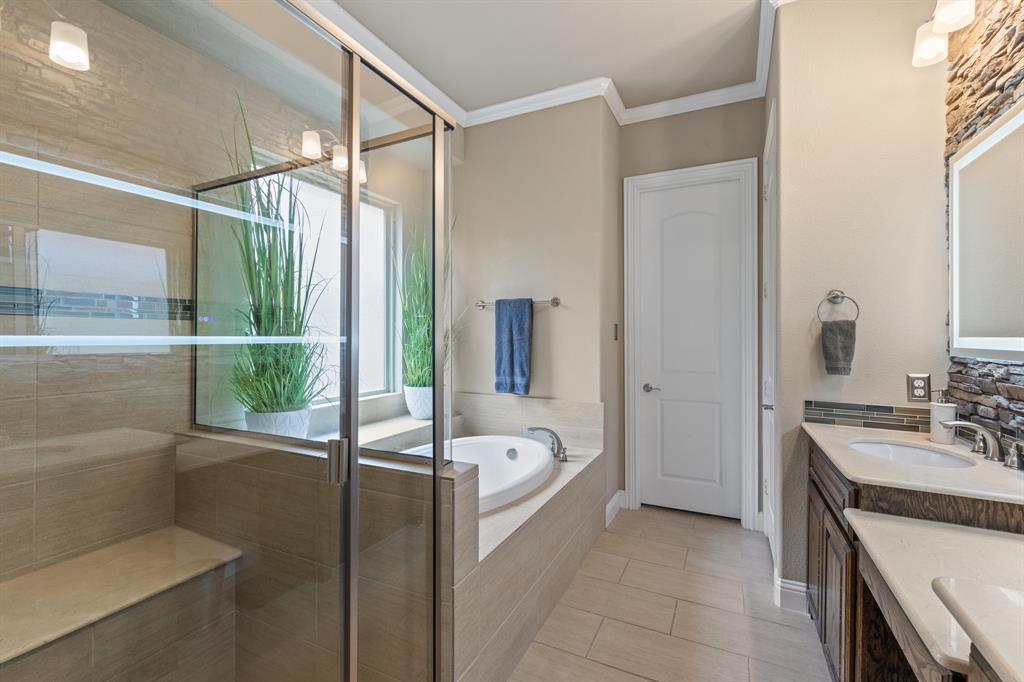 4711 Taylor Lane Grapevine, TX 76051 - Photo 17 of 31 a bathroom with a tub sink and mirror