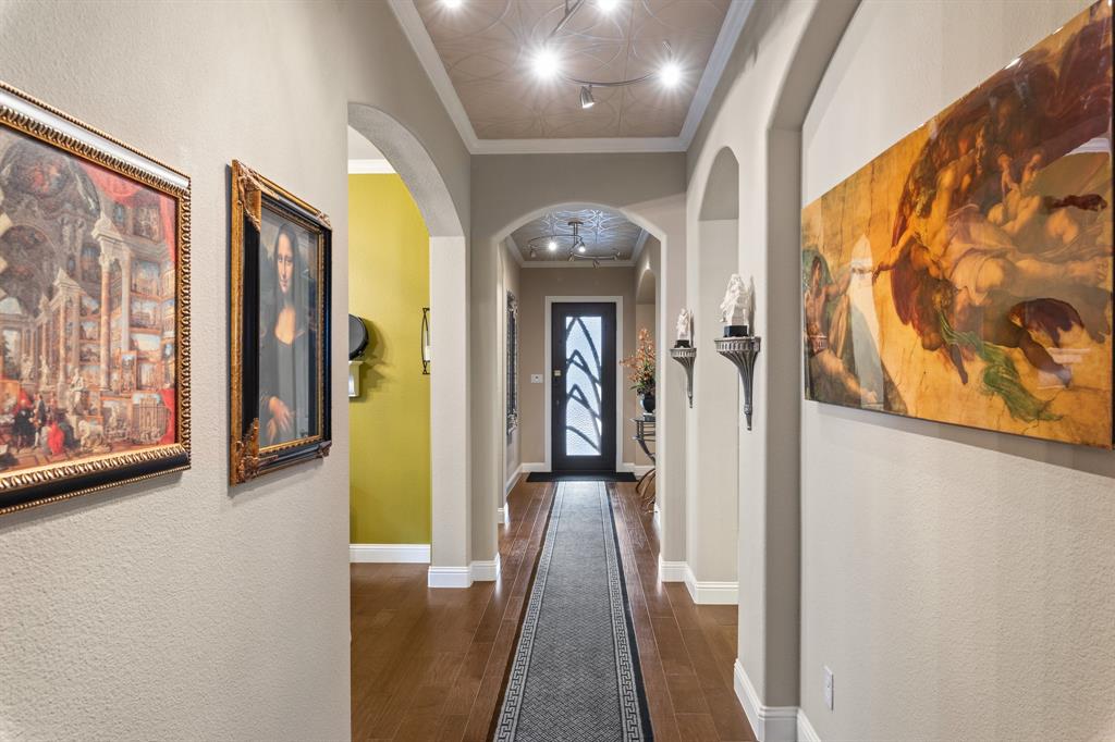 4711 Taylor Lane Grapevine, TX 76051 - Photo 19 of 31 a view of a hallway with wooden floor and windows