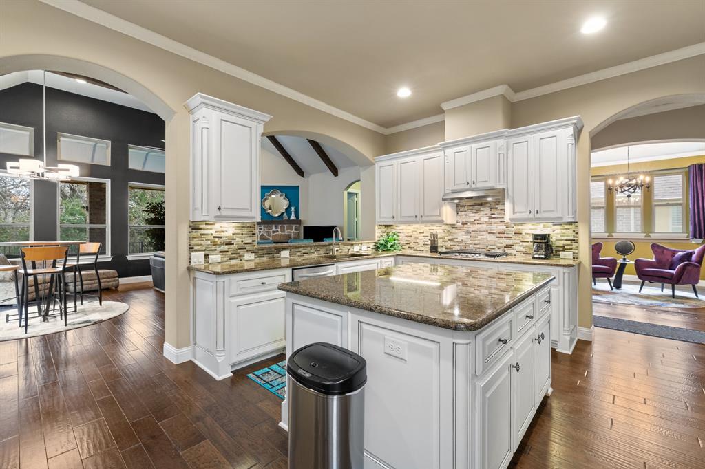 4711 Taylor Lane Grapevine, TX 76051 - Photo 2 of 31 a kitchen with stainless steel appliances granite countertop a kitchen island a stove a sink a dining table and chairs