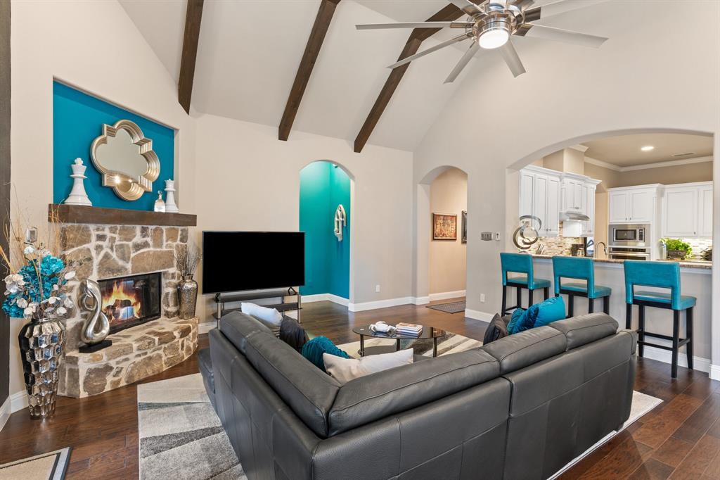 4711 Taylor Lane Grapevine, TX 76051 - Photo 7 of 31 a living room with furniture a fireplace and a flat screen tv