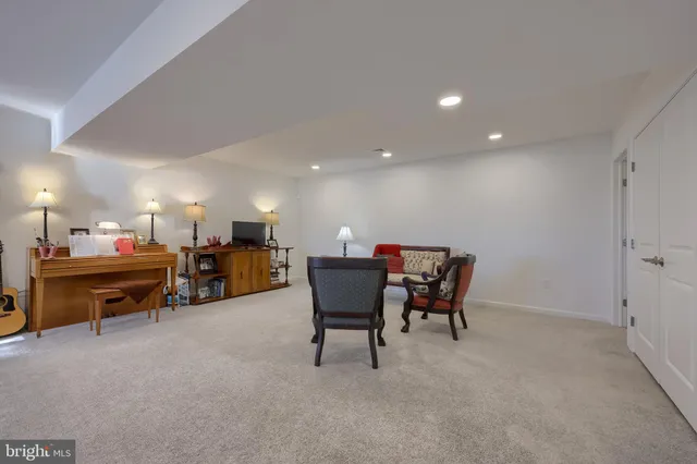 a living room with furniture and a piano
