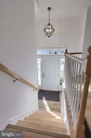 a view of a livingroom with wooden floor and stairs