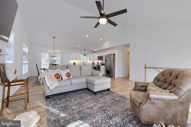 a living room with furniture and a chandelier