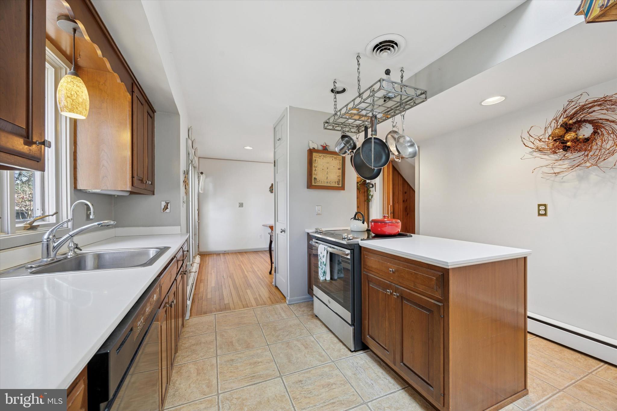 1111 Hagues Mill Road Ambler, PA 19002 - Photo 11 of 31 a kitchen with kitchen island stainless steel appliances a sink stove and refrigerator