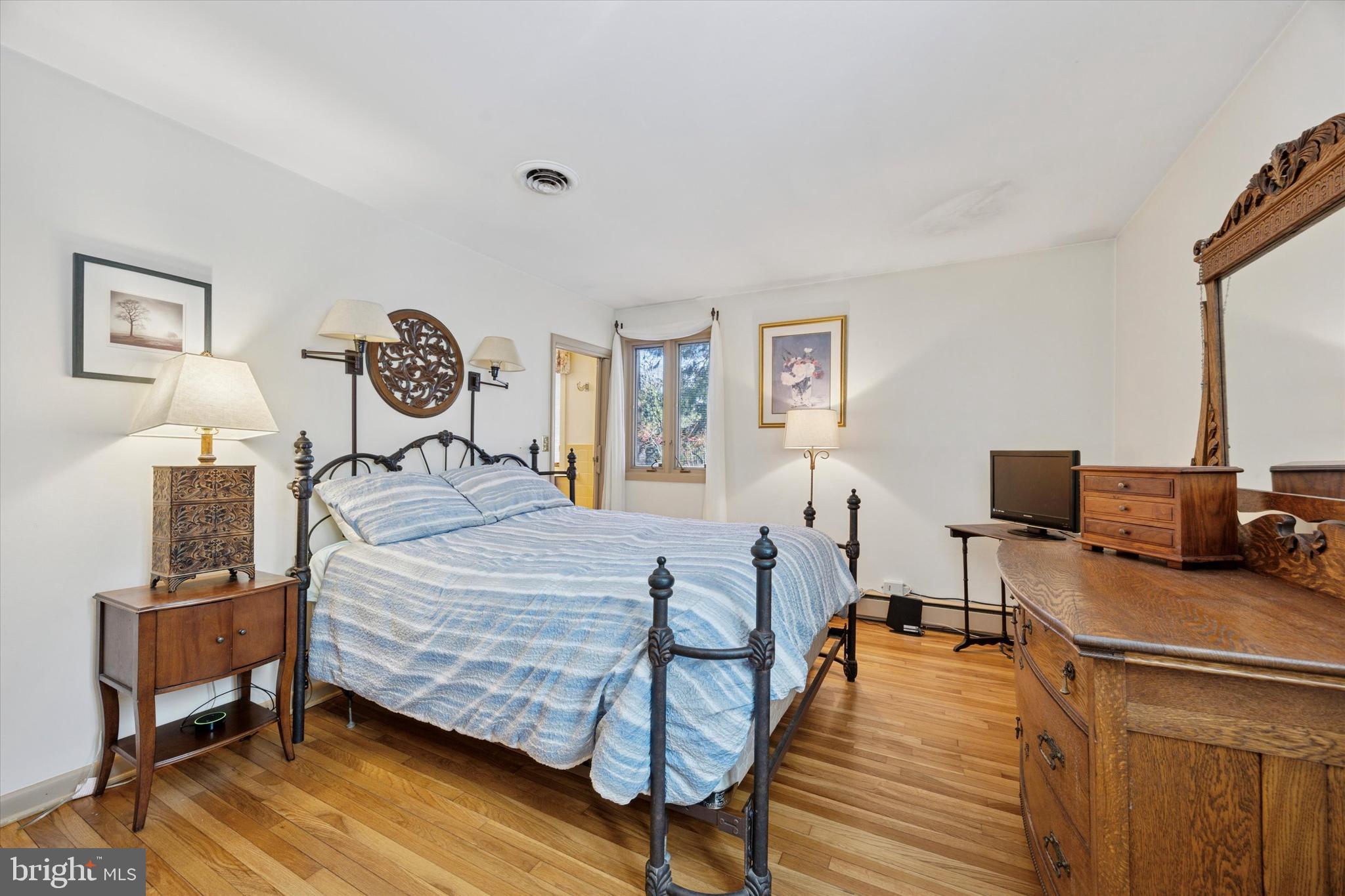 1111 Hagues Mill Road Ambler, PA 19002 - Photo 15 of 31 a bedroom with a bed and wooden floor