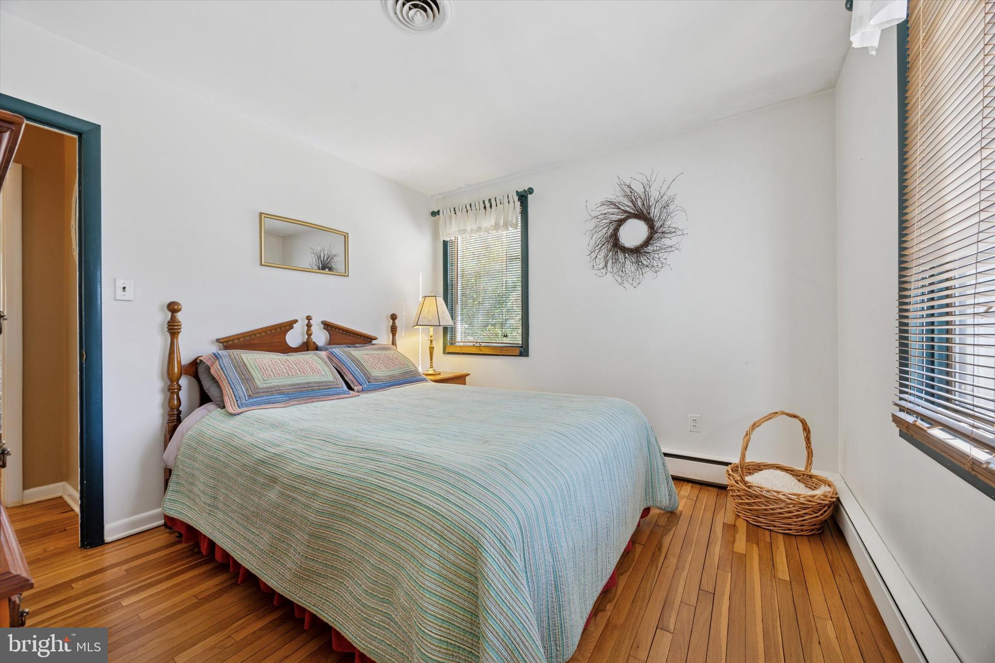 1111 Hagues Mill Road Ambler, PA 19002 - Photo 17 of 31 a bedroom with a bed and wooden floor