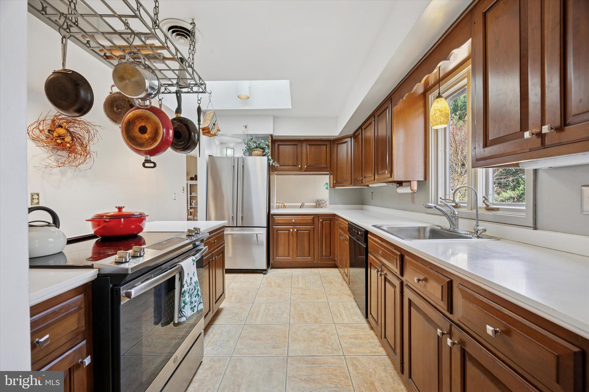 1111 Hagues Mill Road Ambler, PA 19002 - Photo 9 of 31 a kitchen with stainless steel appliances granite countertop a sink a stove and a wooden cabinets