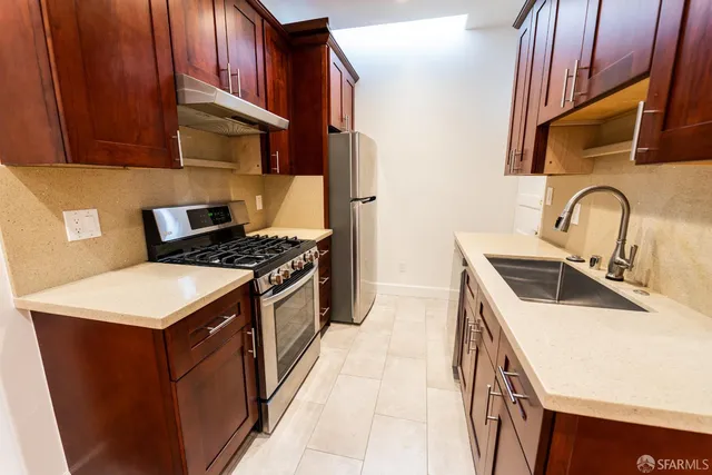 a kitchen that has a sink and a stove
