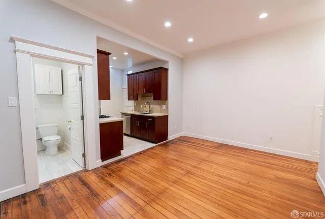 a view of kitchen with a sink and a toilet