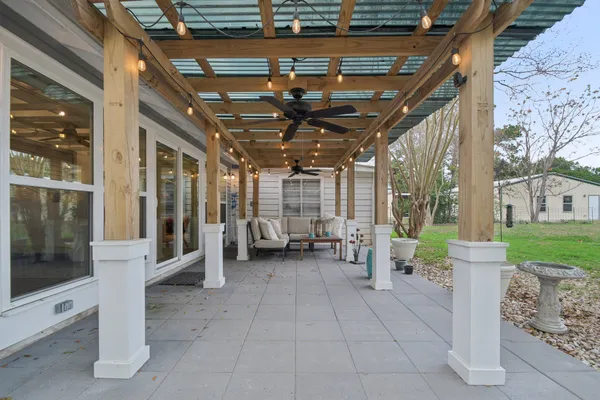 a view of a porch with a table and chairs