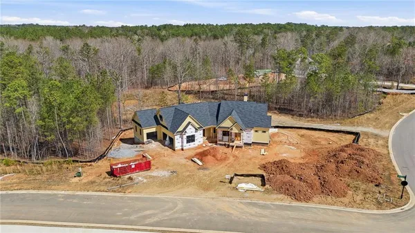 an aerial view of a house with a yard