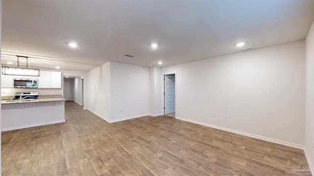 a view of kitchen and refrigerator