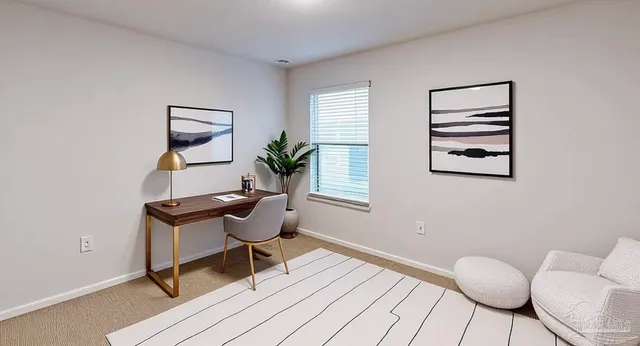 a workspace room with furniture and windows