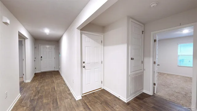 a view of hallway with wooden floor