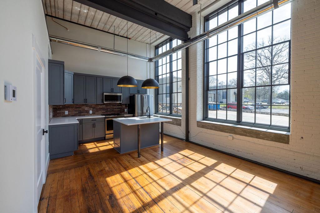 a kitchen with sink cabinets and appliances