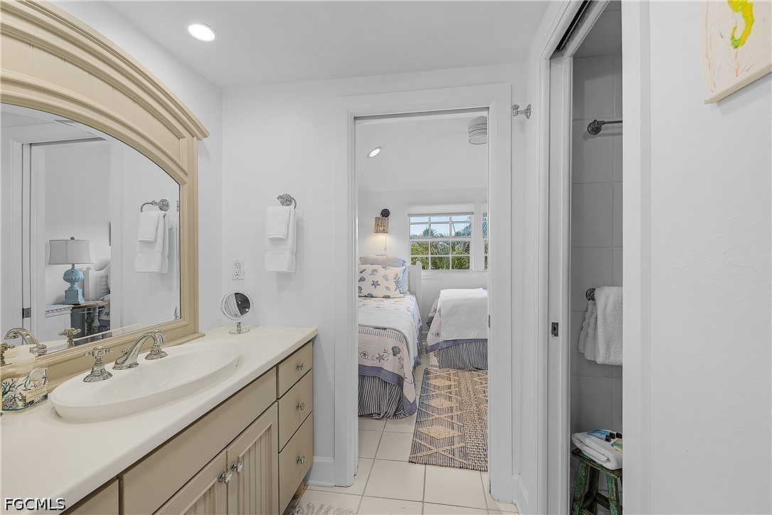 515 Useppa Useppa Island Bokeelia, FL 33922 - Photo 33 of 43 a en suite bathroom with a sink a toilet and a mirror