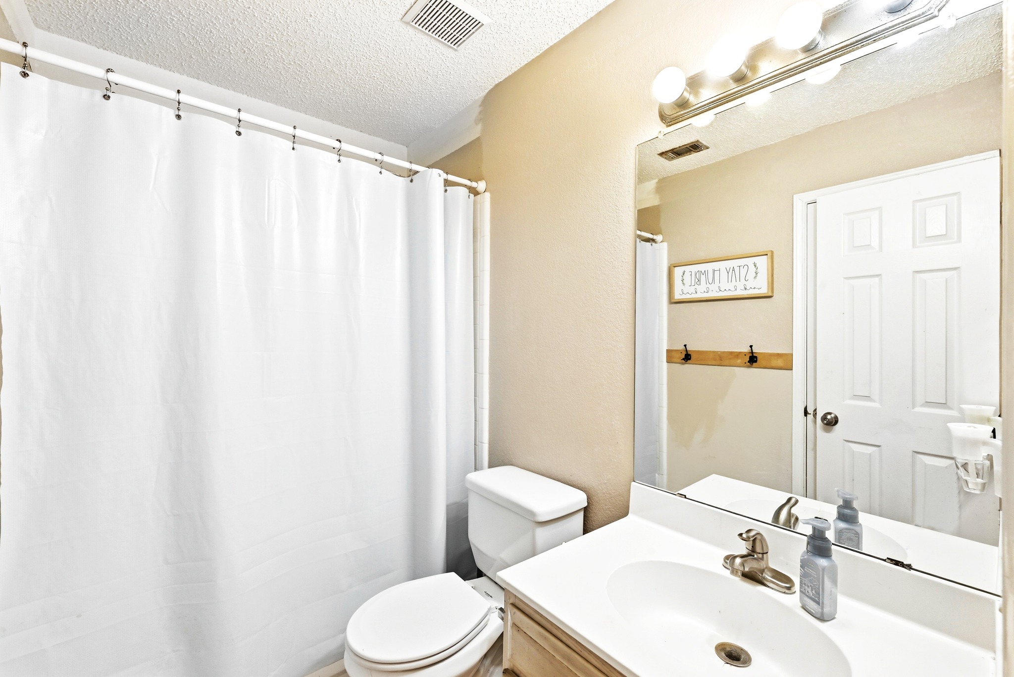 6412 Colton-Bluff Springs Road Austin, TX 78744 - Photo 20 of 27 A well-appointed bathroom with a spacious vanity, large mirror, and full shower.