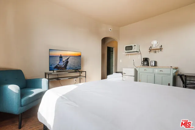 a bedroom with a bed and a television