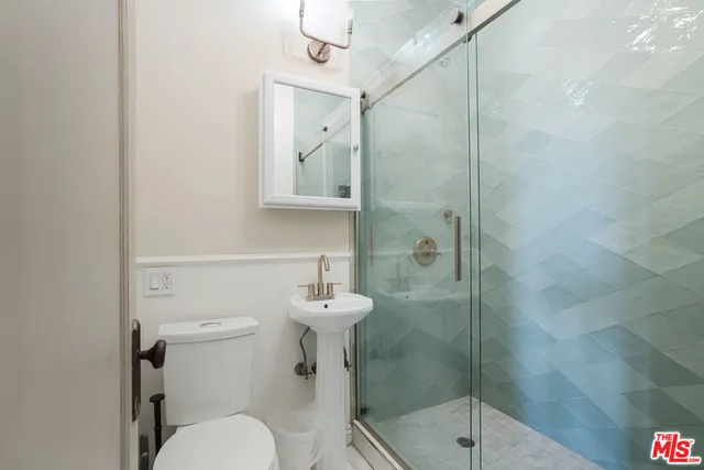 a bathroom with a toilet sink and shower