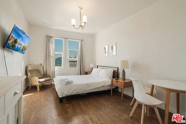 a bedroom with a bed and a chair