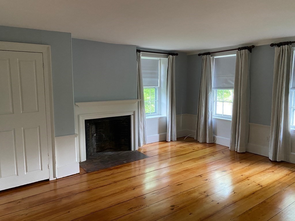 413 Main Street Hingham, MA 02043 - Photo 13 of 33 a view of an empty room with wooden floor and a window