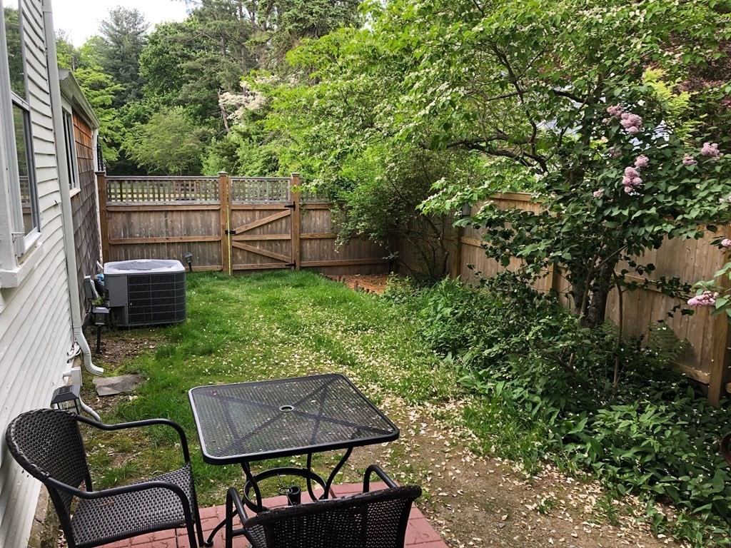 413 Main Street Hingham, MA 02043 - Photo 30 of 33 a backyard of a house with large trees and plants