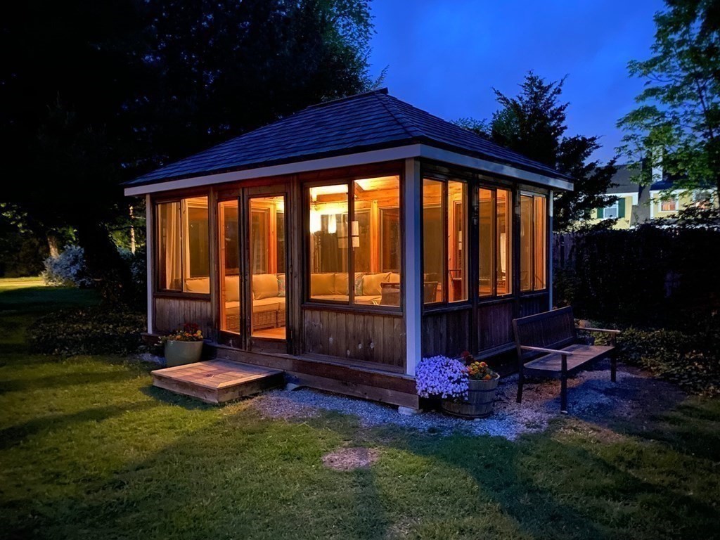 413 Main Street Hingham, MA 02043 - Photo 31 of 33 a backyard of a house with table and chairs with plants