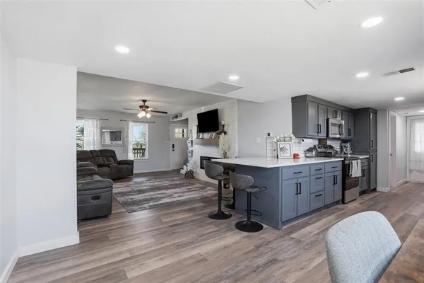 a living room with furniture and a wooden floor