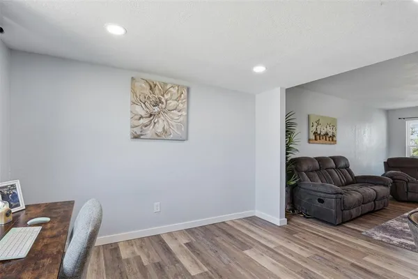a large kitchen with stainless steel appliances lots of counter space and wooden floor