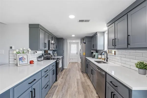 a kitchen with a sink and wooden cabinets