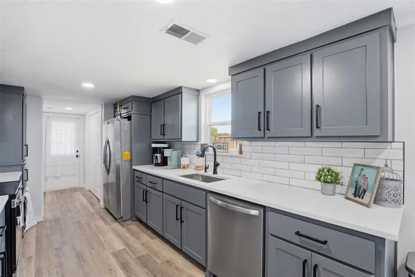 a kitchen with lots of counter space and wooden floor
