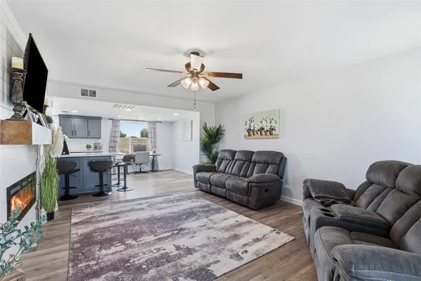 a living room with furniture fireplace and flat screen tv