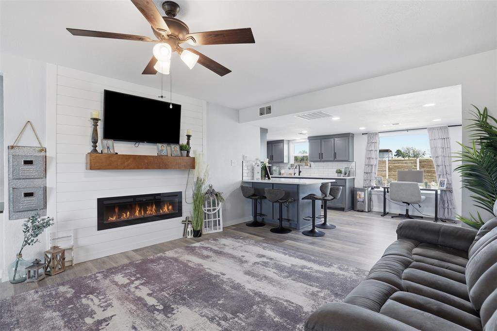 1865 Old Denton Highway Decatur, TX 76234 - Photo 8 of 35 a living room with furniture a fireplace and a flat screen tv