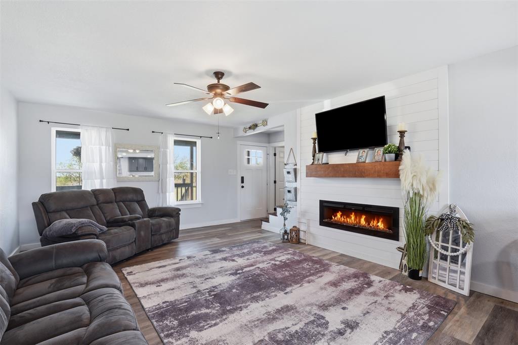 1865 Old Denton Highway Decatur, TX 76234 - Photo 9 of 35 a living room with furniture a flat screen tv and a fireplace