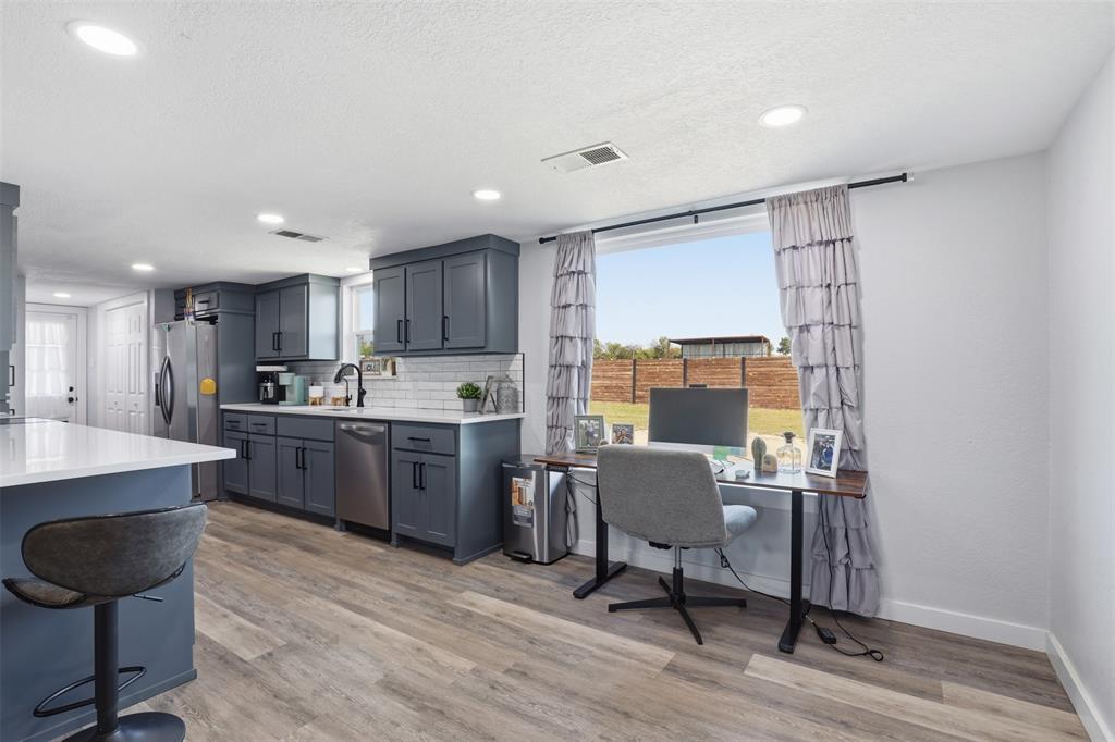 1865 Old Denton Highway Decatur, TX 76234 - Photo 10 of 35 a kitchen with a table chairs refrigerator and chairs